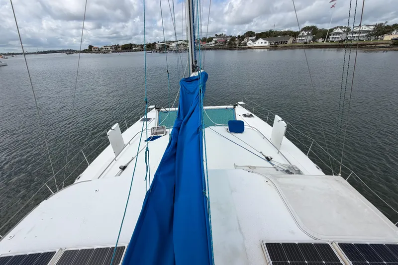 Slide: The Image of Sailboat Dolphin 460, 2007 model, anchored in calm waters with a blue sail cover. - 40