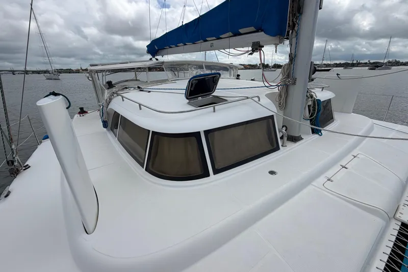 Slide: The Image of Sailing catamaran Dolphin 460, 2007 model, with blue sail cover, docked in a marina. - 41