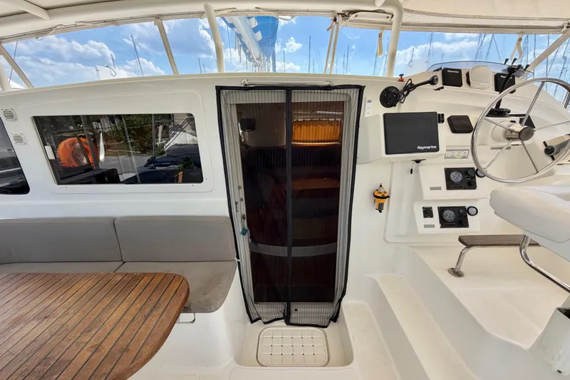 Slide: The Image of Cockpit of 2007 Dolphin 460 yacht with steering wheel and navigation equipment. - 42