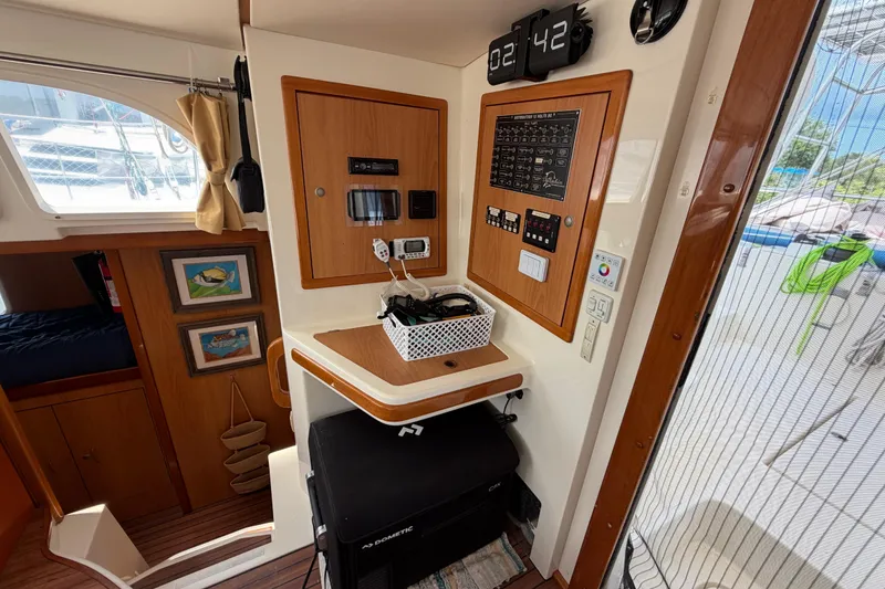 Slide: The Image of Interior of a 2007 Dolphin 460 yacht featuring control panels and nautical decor. - 50
