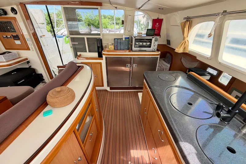Slide: The Image of Interior of a 2007 Dolphin 460 yacht with modern kitchen and wooden flooring. - 52