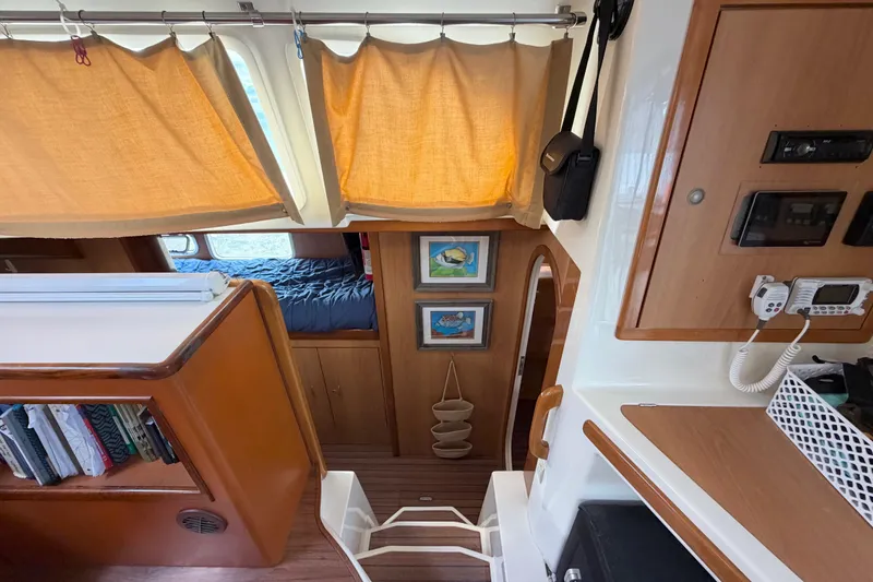 Slide: The Image of Interior of 2007 Dolphin 460 sailboat with cozy cabin, wooden accents, and nautical decor. - 55