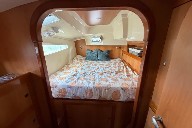 Slide: The Image of Cozy cabin interior of 2007 Dolphin 460 yacht with bed and wooden finish. - 57