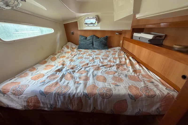 Slide: The Image of Cozy cabin bedroom in 2007 Dolphin 460 yacht with fruit-patterned bedding. - 58