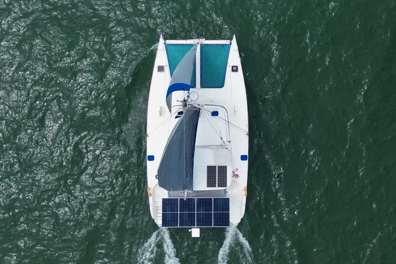 Slide: The Image of Aerial view of 2007 Dolphin 460 catamaran sailing with solar panels on deck. - 6