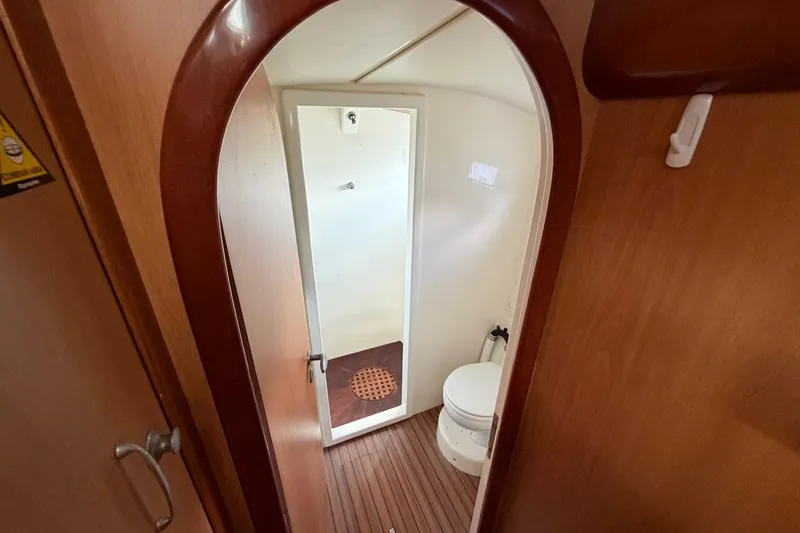 Slide: The Image of Compact bathroom in 2007 Dolphin 460 yacht with wooden accents and modern fixtures. - 65