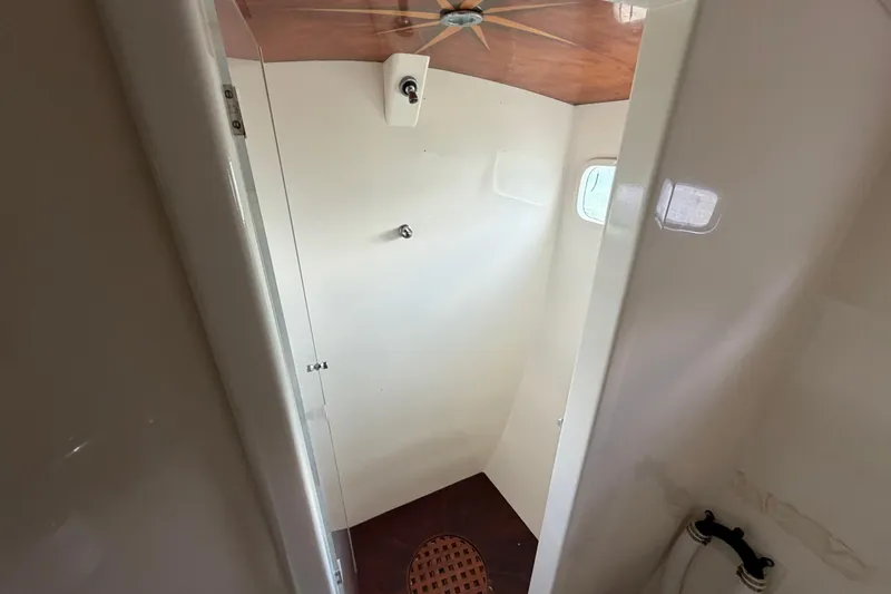 Slide: The Image of Compact bathroom interior of 2007 Dolphin 460 yacht with wooden accents and small window. - 67