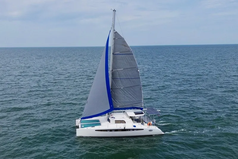 Slide: The Image of Sailing catamaran Dolphin 460, 2007 model, cruising on open sea under clear skies. - 7