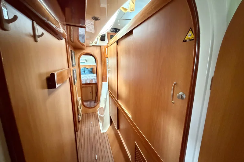 Slide: The Image of Interior hallway of a 2007 Dolphin 460 yacht with wooden paneling and cozy cabin view. - 70