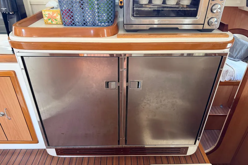 Slide: The Image of Stainless steel cabinet with wooden trim in a Dolphin 460 yacht kitchen, 2007 model. - 71