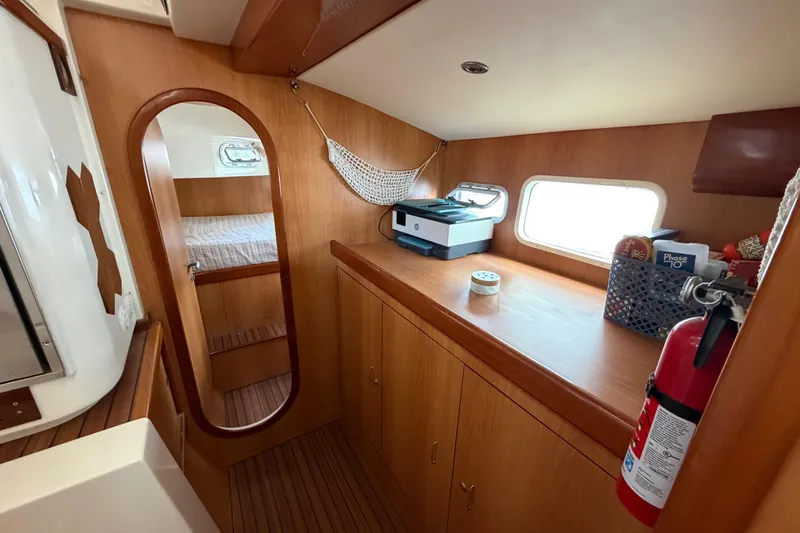 Slide: The Image of Interior of 2007 Dolphin 460 yacht with wooden cabinetry and a fire extinguisher. - 73