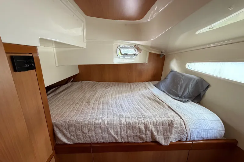 Slide: The Image of Cozy cabin interior of 2007 Dolphin 460 yacht with comfortable bed and wooden accents. - 74