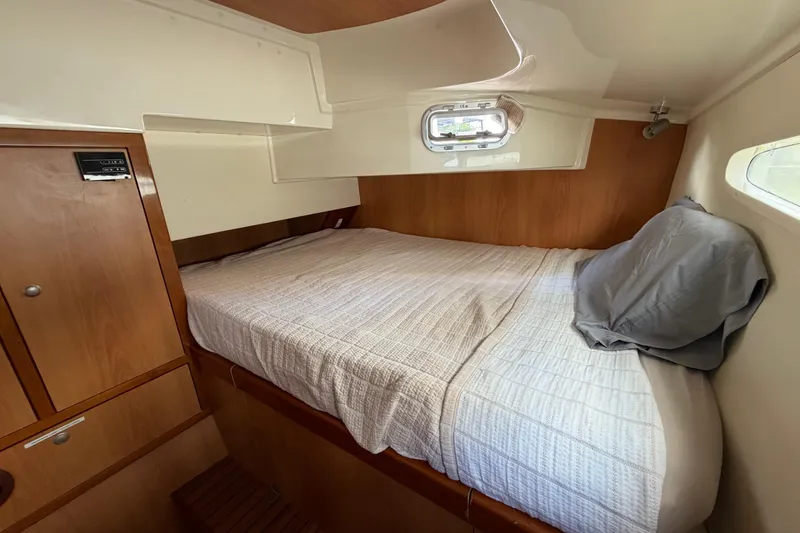 Slide: The Image of Cozy cabin interior of 2007 Dolphin 460 yacht with bed and wooden cabinetry. - 75