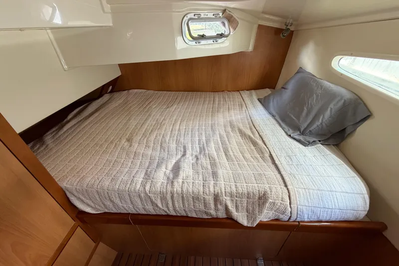 Slide: The Image of Cozy cabin bed in 2007 Dolphin 460 yacht with wooden interior and window view. - 76