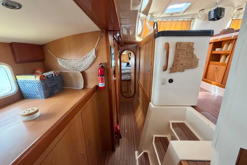 Slide: The Image of Interior of 2007 Dolphin 460 yacht with wooden cabinetry and cozy living space. - 78