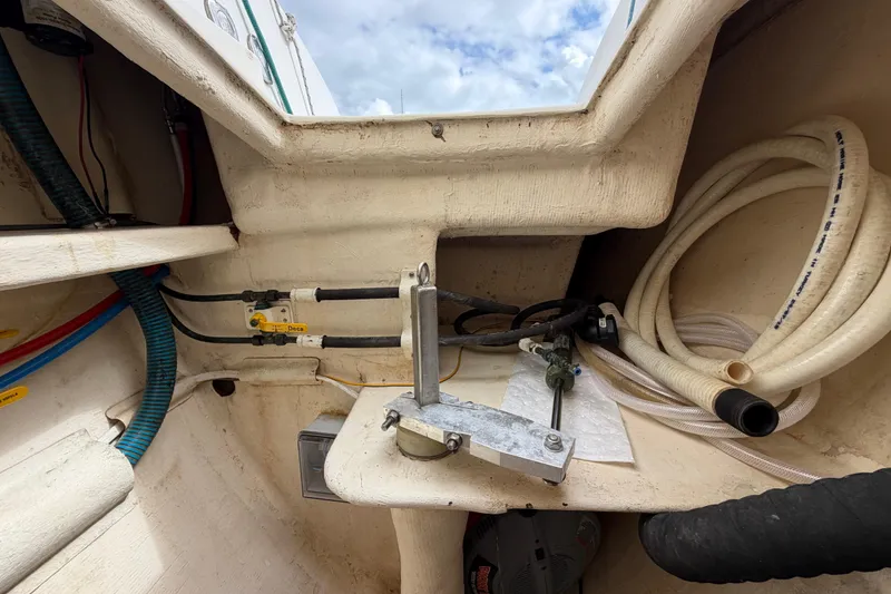 Slide: The Image of Interior view of a 2007 Dolphin 460 boat showing plumbing and hoses. - 89