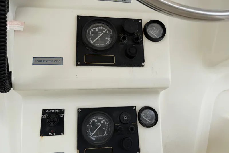 Slide: The Image of Control panel of a 2007 Dolphin 460 boat, featuring gauges and switches. - 93
