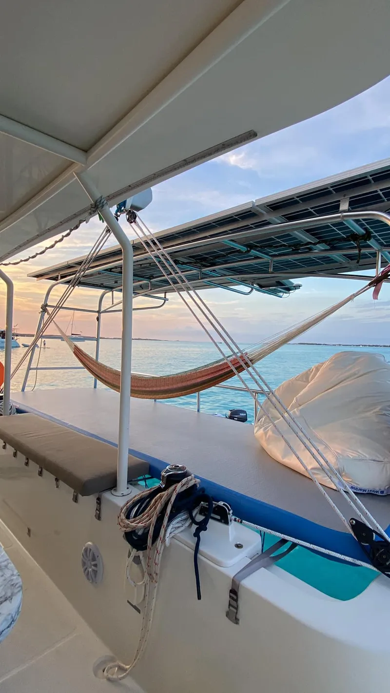 Slide: The Image of Sailing yacht Dolphin 460, 2007 model, with hammock and ocean view at sunset. - 94