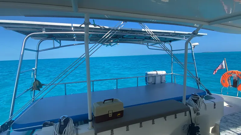 Slide: The Image of Dolphin 460 catamaran deck overlooking clear blue ocean, 2007 model. - 95