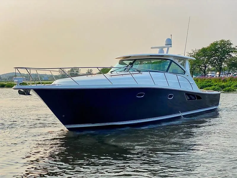 The Image of 2014 Tiara Yachts 43 Open on calm water at sunset. - 0