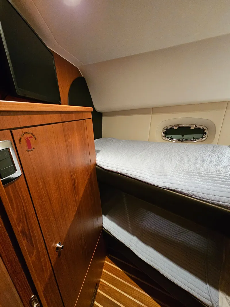 Slide: The Image of Interior of 2014 Tiara Yachts 43 Open with wood furnishings and bed. - 19