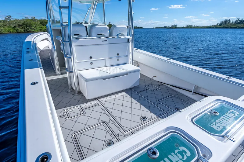 Slide: The Image of 2019 Contender 39 Fisharound boat interior with seating, on a calm blue lake. - 13