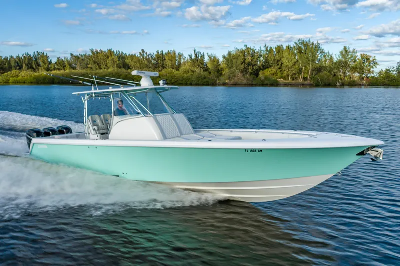 Slide: The Image of 2019 Contender 39 Fisharound cruising on a serene lake under a clear blue sky. - 2