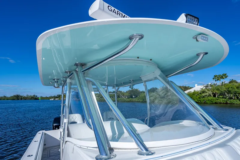 Slide: The Image of 2019 Contender 39 Fisharound boat with sleek design on a serene waterway. - 20