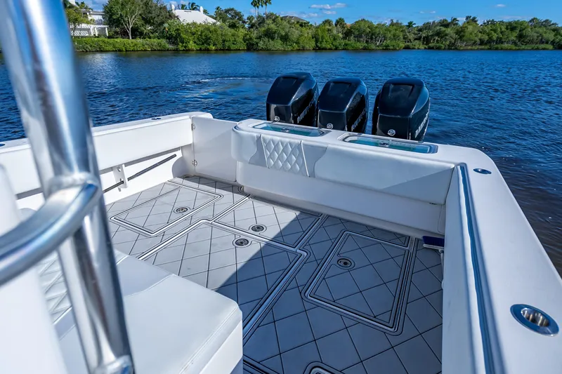 Slide: The Image of 2019 Contender 39 Fisharound boat with triple outboard engines on a serene lake. - 21