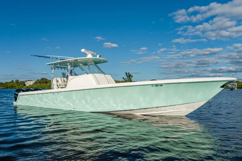 Slide: The Image of 2019 Contender 39 Fisharound boat on calm water under blue sky. - 22