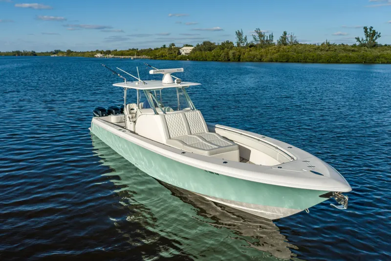 Slide: The Image of 2019 Contender 39 Fisharound boat on calm water, clear sky background. - 23