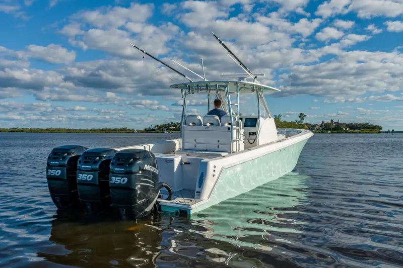 Slide: The Image of 2019 Contender 39 Fisharound boat with triple Mercury 350 engines on calm water. - 24