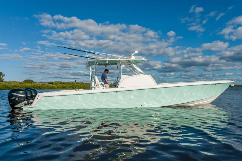 Slide: The Image of 2019 Contender 39 Fisharound boat on calm water under a blue sky. - 27
