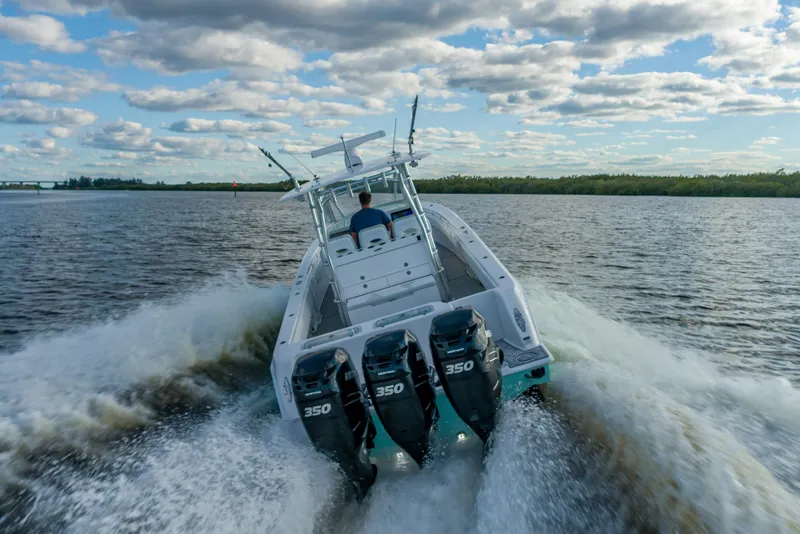 Slide: The Image of 2019 Contender 39 Fisharound boat cruising on open water under a cloudy sky. - 28