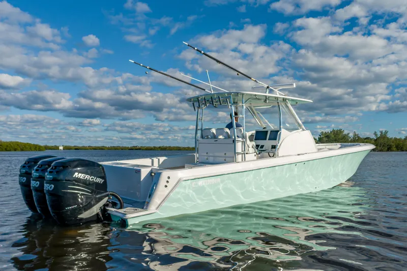 Slide: The Image of 2019 Contender 39 Fisharound boat with triple Mercury engines on calm water. - 3