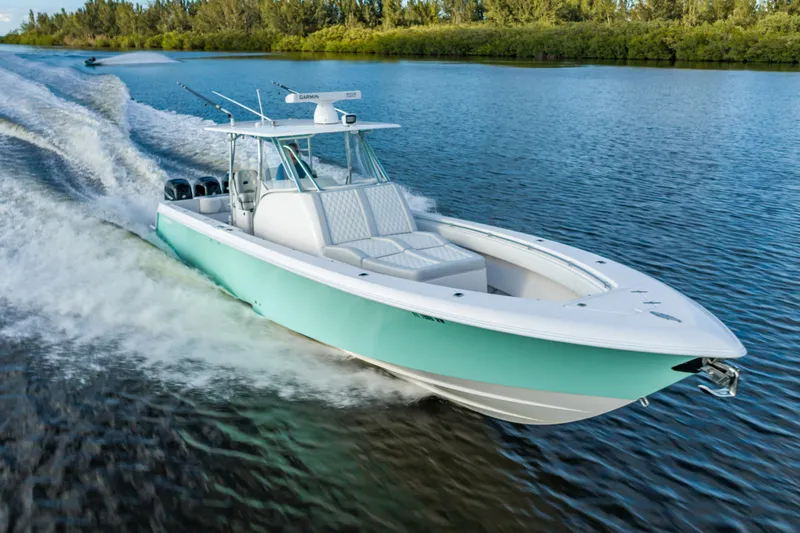 Slide: The Image of 2019 Contender 39 Fisharound boat cruising on a scenic waterway. - 30