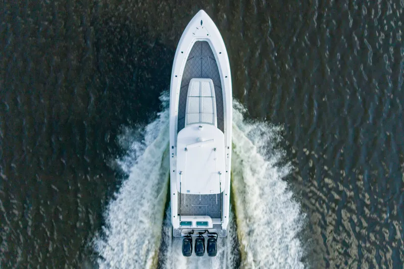 Slide: The Image of Aerial view of 2019 Contender 39 Fisharound boat cruising on water. - 4