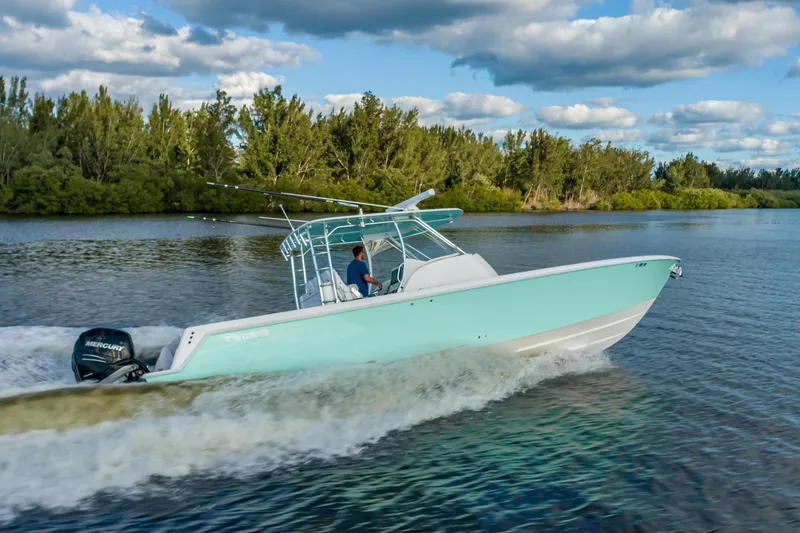 Slide: The Image of 2019 Contender 39 Fisharound cruising on a scenic waterway under a partly cloudy sky. - 6