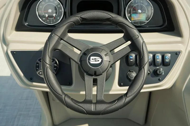 Slide: The Image of Steering wheel and dashboard of 2026 Dockside 20DQ boat, featuring modern controls. - 16