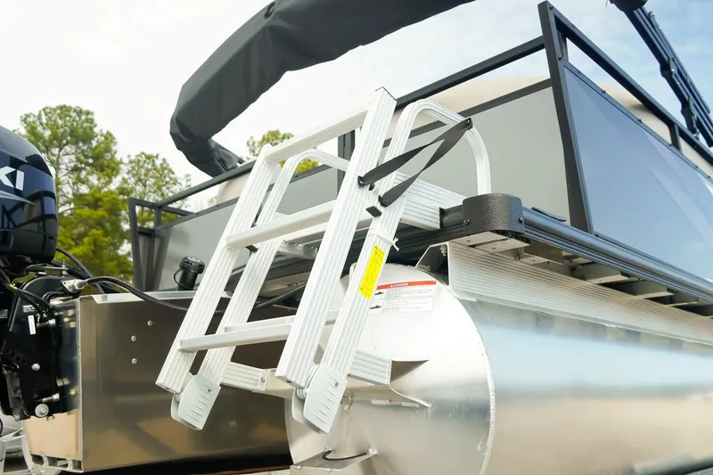 Slide: The Image of Dockside 20DQ 2026 pontoon boat with ladder and motor, featuring sleek design. - 32
