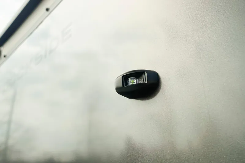Slide: The Image of Close-up of a 2026 Dockside 20DQ exterior light on a metallic surface. - 34