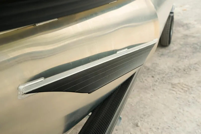 Slide: The Image of Close-up of 2026 Dockside 20DQ boat hull detail on sandy ground. - 35