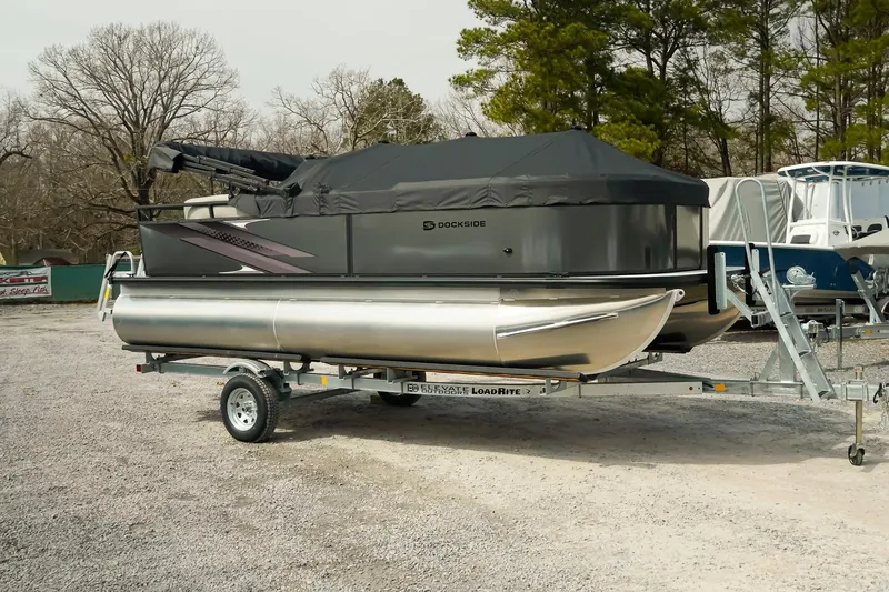 Slide: The Image of 2026 Dockside 20DQ pontoon boat on trailer, covered and parked outdoors. - 4