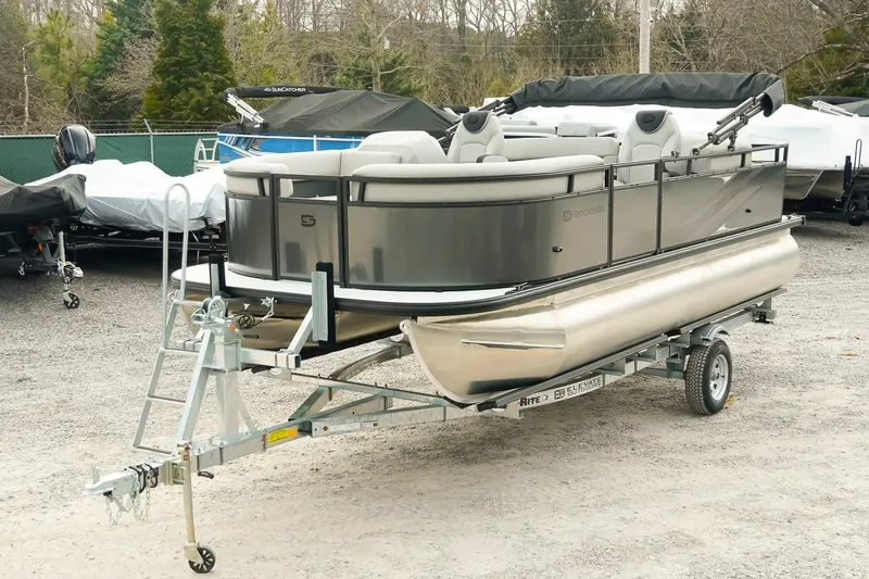 Slide: The Image of 2026 Dockside 20DQ pontoon boat on trailer in outdoor storage area. - 7