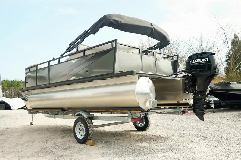 Slide: The Image of 2026 Dockside 20DQ pontoon boat with Suzuki outboard motor on trailer. - 8