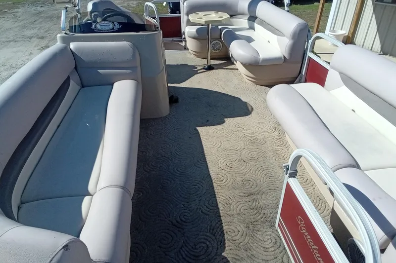 Slide: The Image of 2014 Sun Tracker Party Barge 20 DLX interior with spacious seating and table. - 4