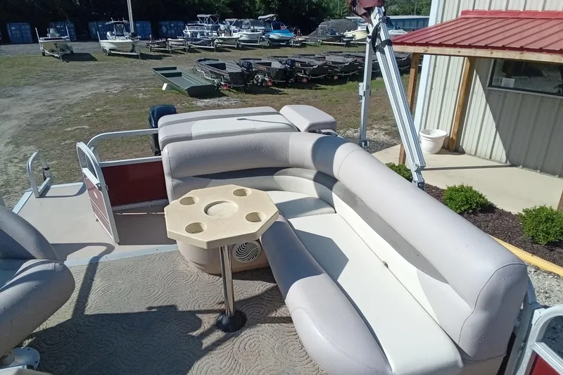 Slide: The Image of 2014 Sun Tracker Party Barge 20 DLX with beige seating and cupholder table. - 6
