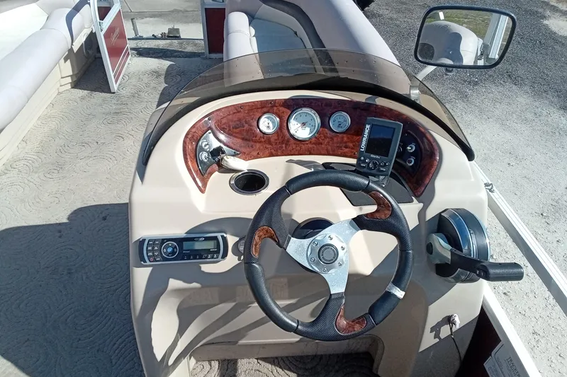 Slide: The Image of 2014 Sun Tracker Party Barge 20 DLX helm with steering wheel and control panel. - 8