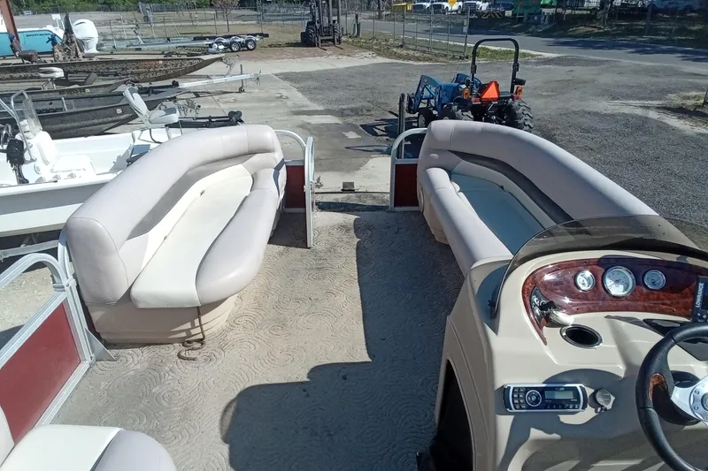 Slide: The Image of 2014 Sun Tracker Party Barge 20 DLX interior with seating and control panel. - 9