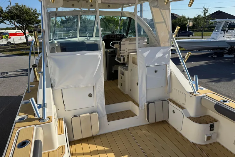 Slide: The Image of 2007 Pursuit OS 335 Offshore boat interior with teak flooring and helm station. - 10